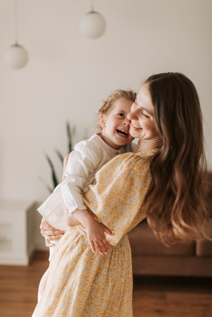 Mother Carrying Her Daughter Both Smiling